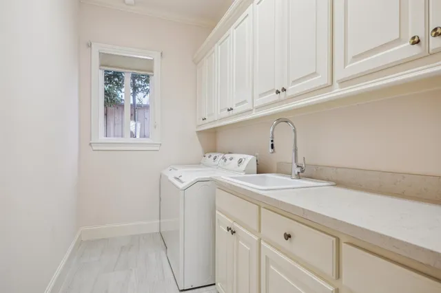 a view of a kitchen with wooden floor and cabinets
