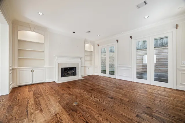 a view of an empty room with a fireplace and a window