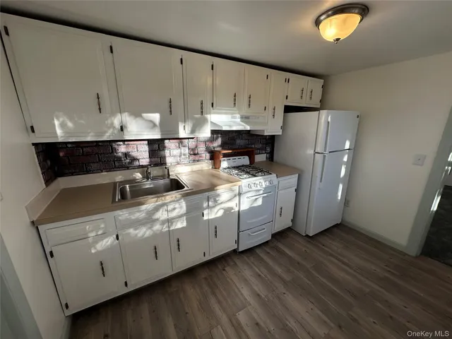 a kitchen with cabinets and white appliances