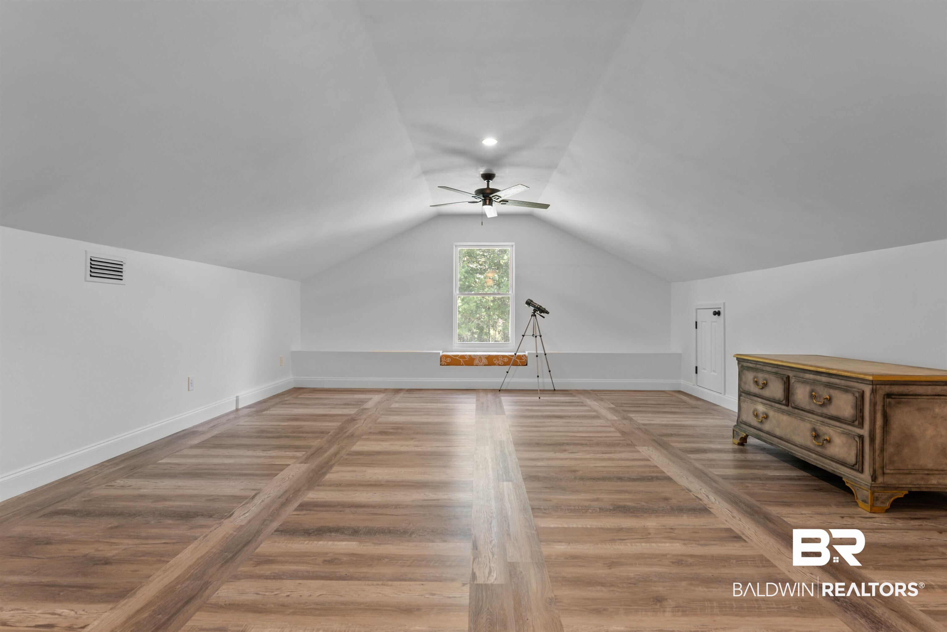 6447 Bemis Lane Bon Secour, AL 36511 - Photo 41 of 62 Spacious attic room featuring wood-finish flooring with a central plank design, white sloped ceilings, and recessed lighting