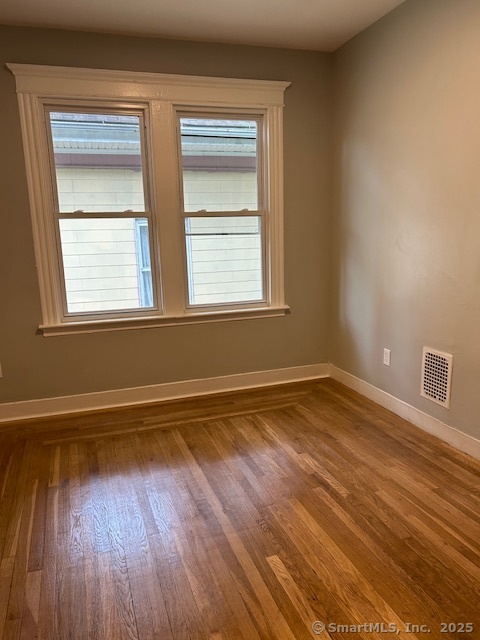 514 Winthrop Avenue New Haven, CT 06511 - Photo 6 of 17 a view of an empty room with wooden floor and a window