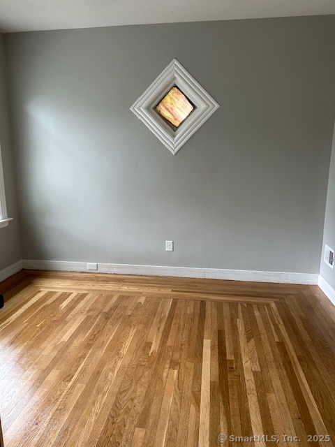 514 Winthrop Avenue New Haven, CT 06511 - Photo 7 of 17 a view of a room with wooden floor and white walls