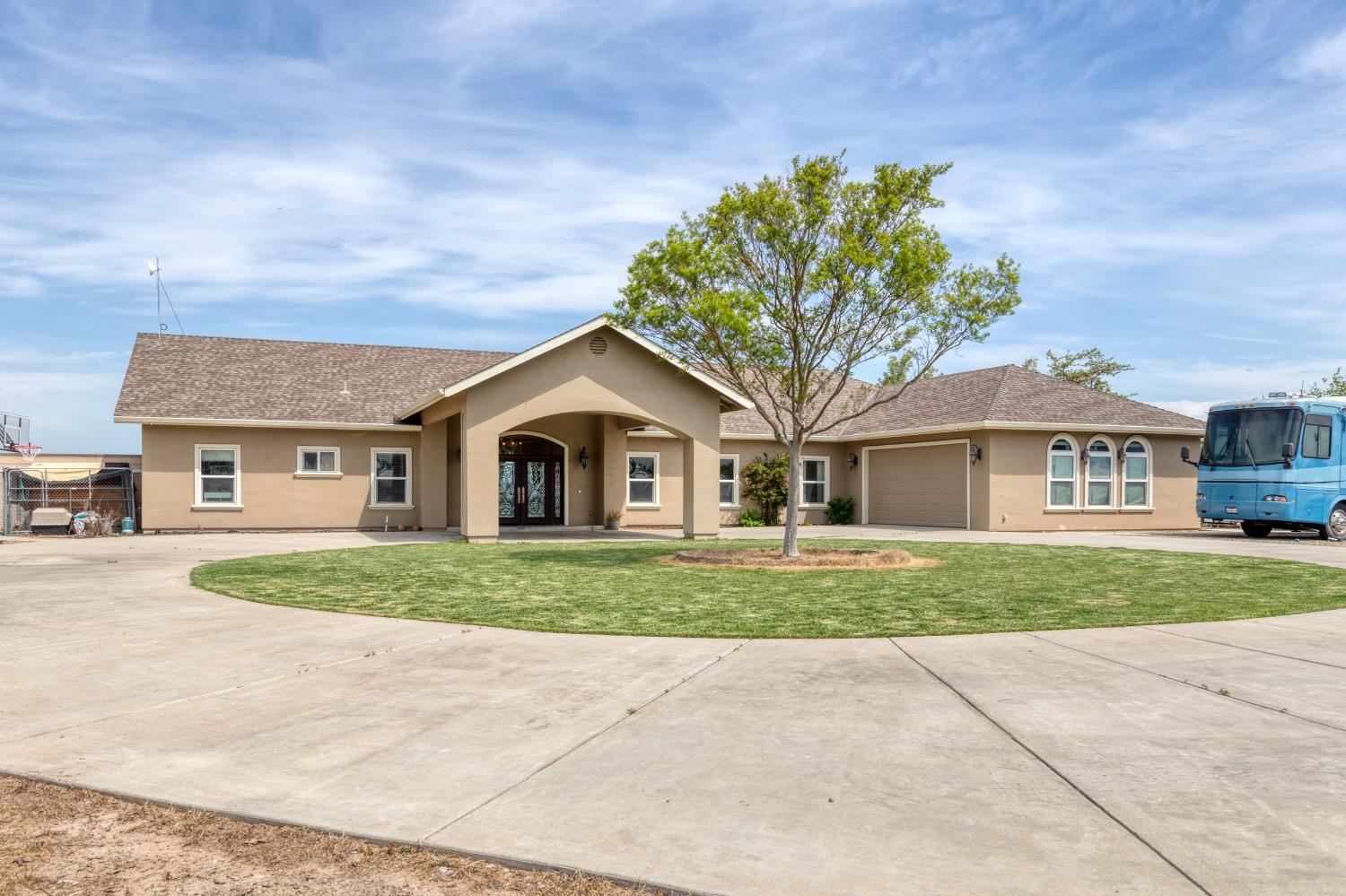 30257 Grooms Road Oakdale, CA 95361 - Photo 1 of 1 a front view of a house with a yard and garage