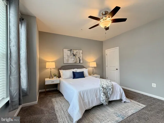 a living room with furniture potted plant and a chandelier