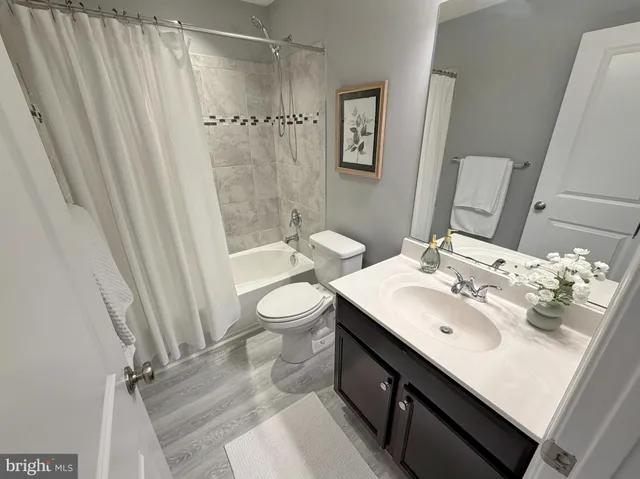a living room with furniture a dining table and kitchen view