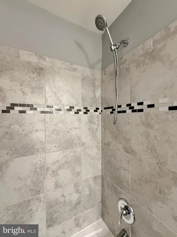 a metallic refrigerator freezer sitting in a kitchen