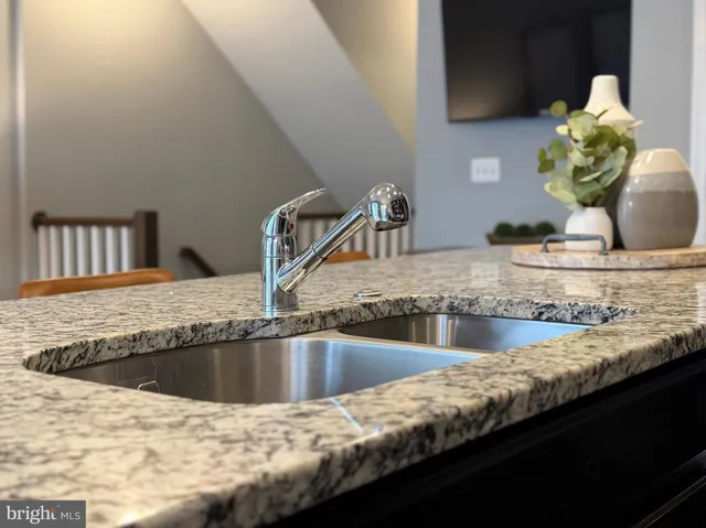 a bedroom with a bed and a lamp on dresser