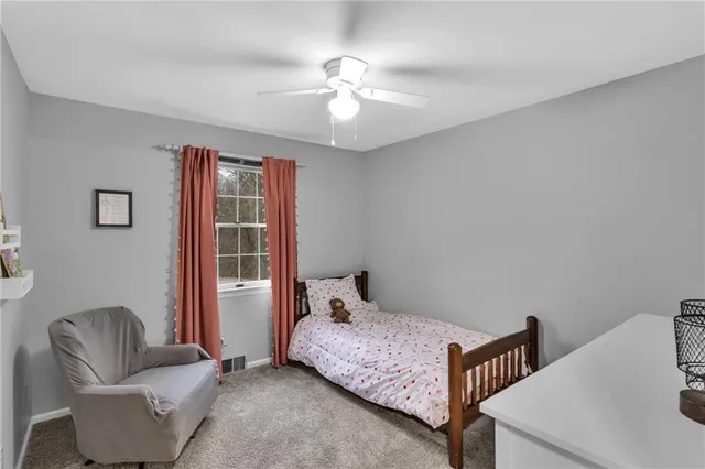a bedroom with furniture and a window