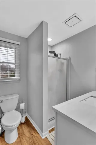 a bathroom with a toilet sink and shower