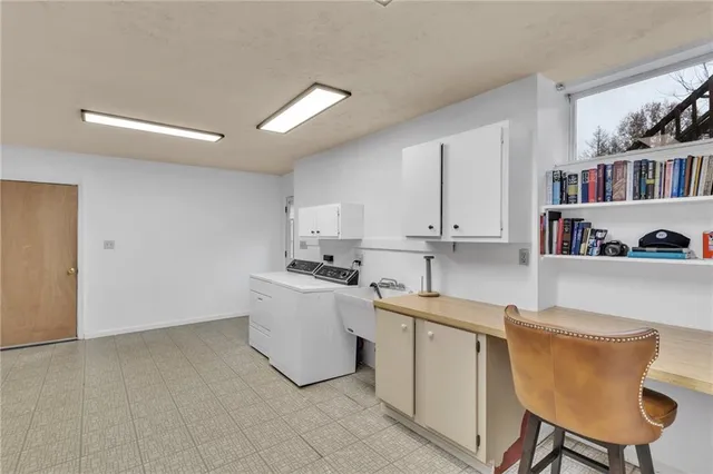 a room with a sink cabinets and utility room