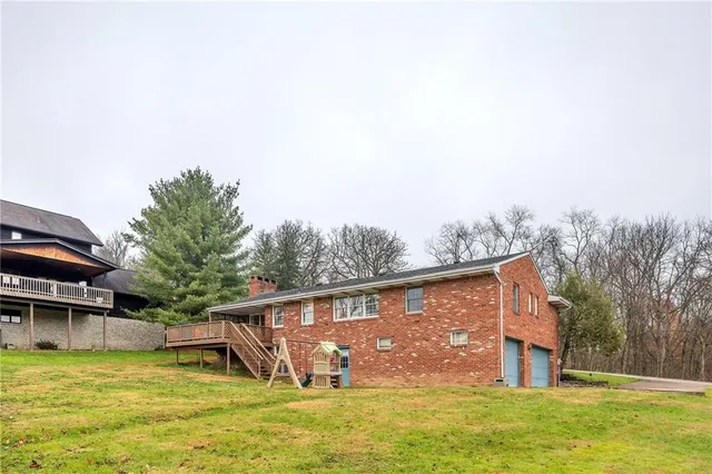 a view of a house with pool and chairs
