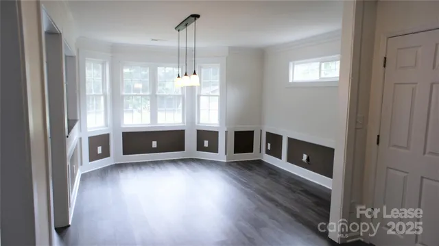 a view of wooden floor and windows in a room
