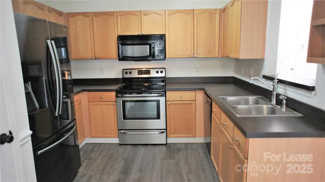 a kitchen with a sink stove and refrigerator