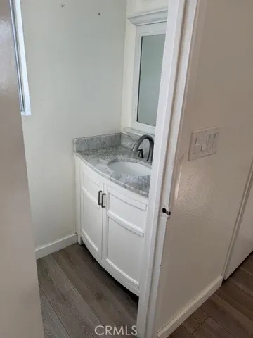 a bathroom with a granite countertop sink and vanity