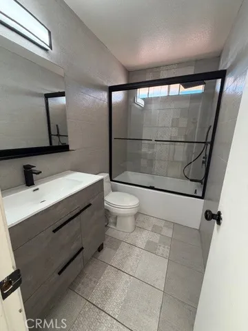 a bathroom with a sink mirror vanity and toilet