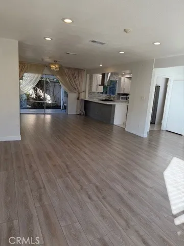 a view of kitchen with cabinets and wooden floor