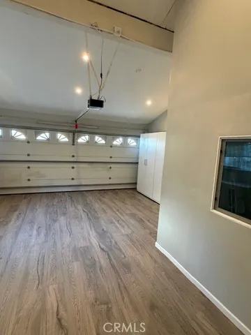 a view of a room with wooden floor