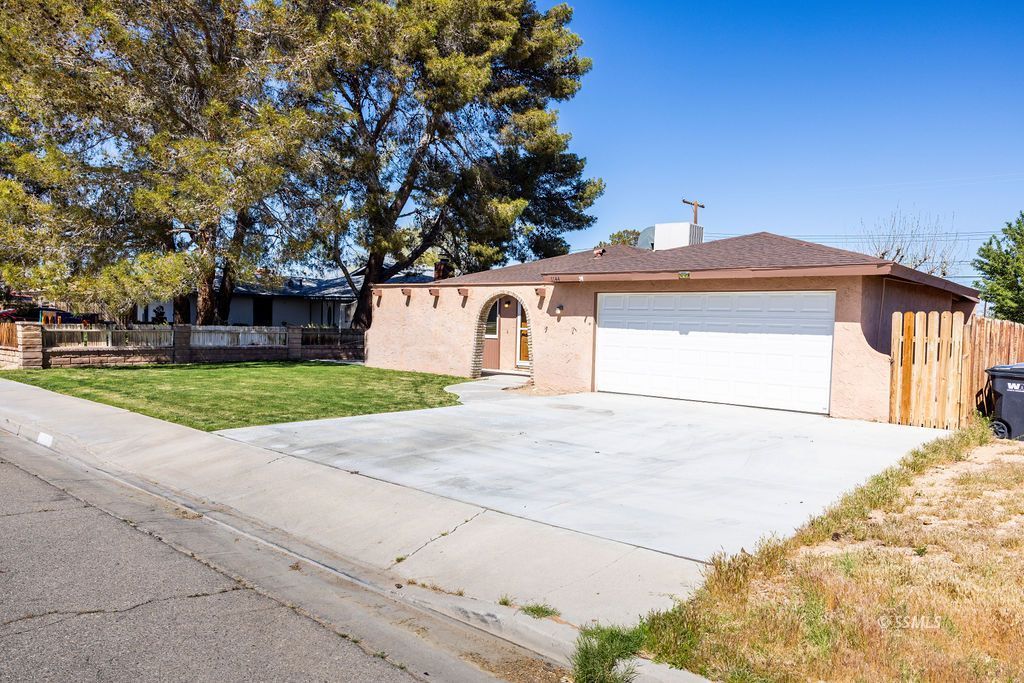 1144 West Benson Avenue Ridgecrest, CA 93555 - Photo 2 of 32 a front view of a house with garden