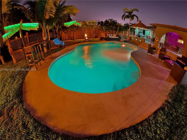 a room with furniture pool table and a flat screen tv