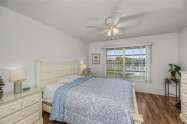 a bedroom with a large bed and a chandelier