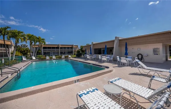 a view of swimming pool with outdoor seating