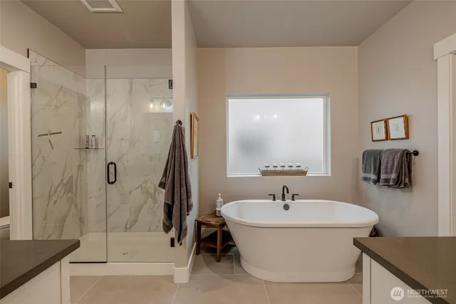 a white bath tub sitting next to a bathroom sink
