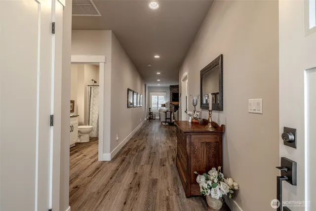 a view of a hallway and wooden floor