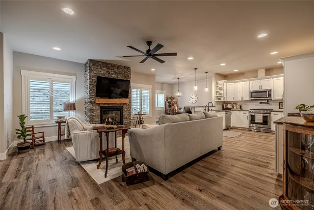 a living room with furniture a fireplace and a flat screen tv