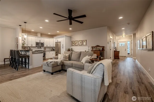 a living room with furniture and kitchen view