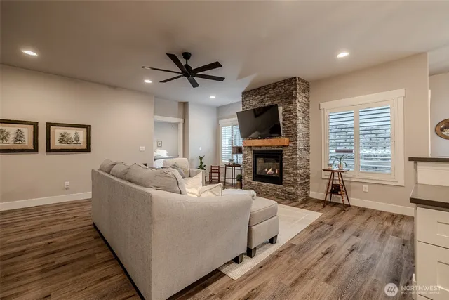 a living room with furniture a fireplace and a flat screen tv