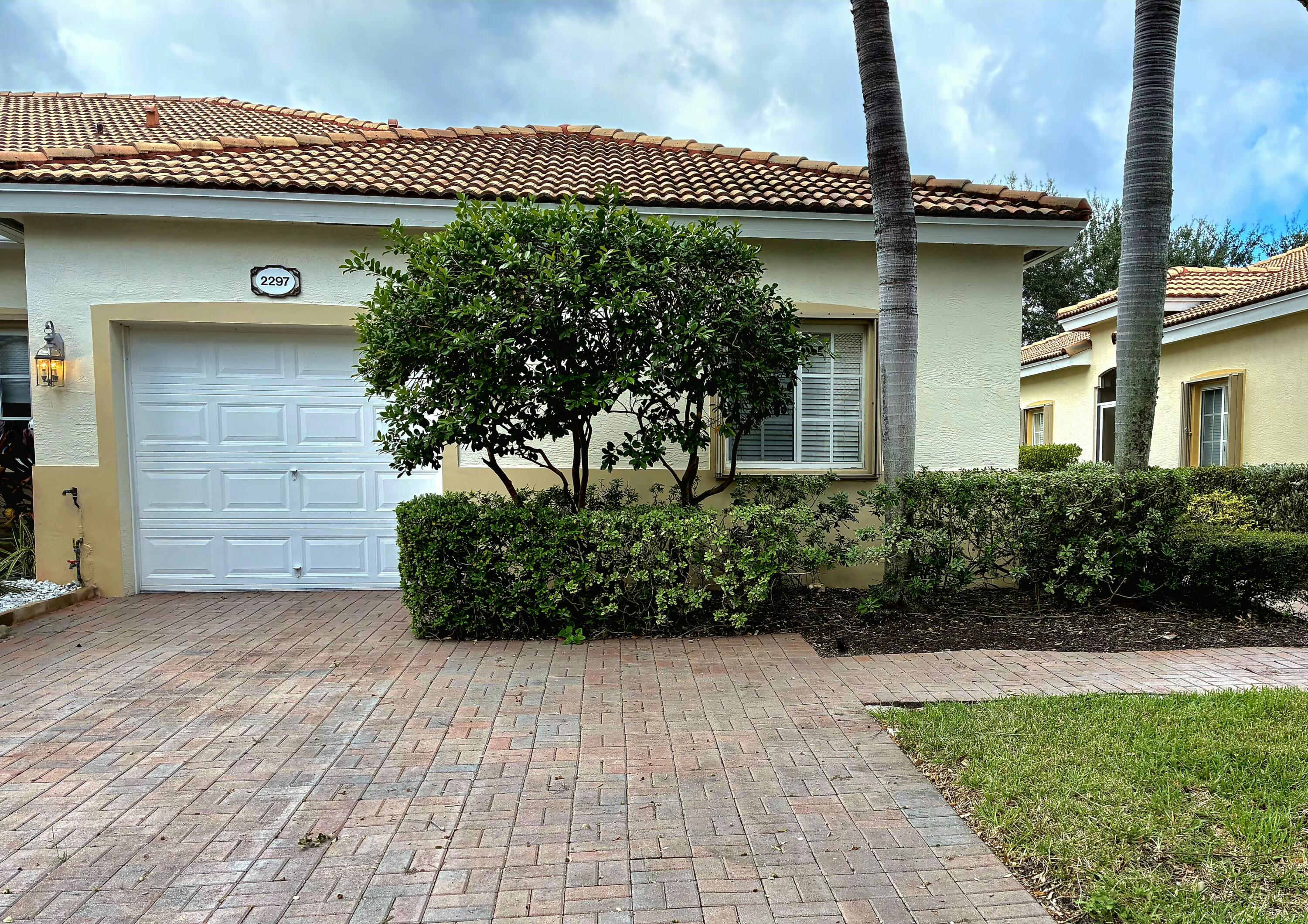 2297 Windjammer Way West Palm Beach, FL 33411 - Photo 1 of 56 a front view of a house with a yard