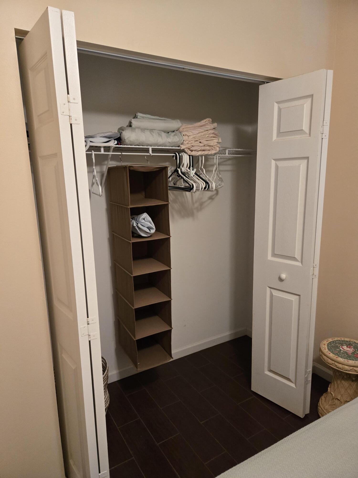 2297 Windjammer Way West Palm Beach, FL 33411 - Photo 12 of 56 a view of walk in closet with clothes and shoes