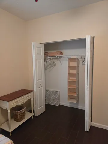 a bathroom with a granite countertop sink toilet a mirror and shower