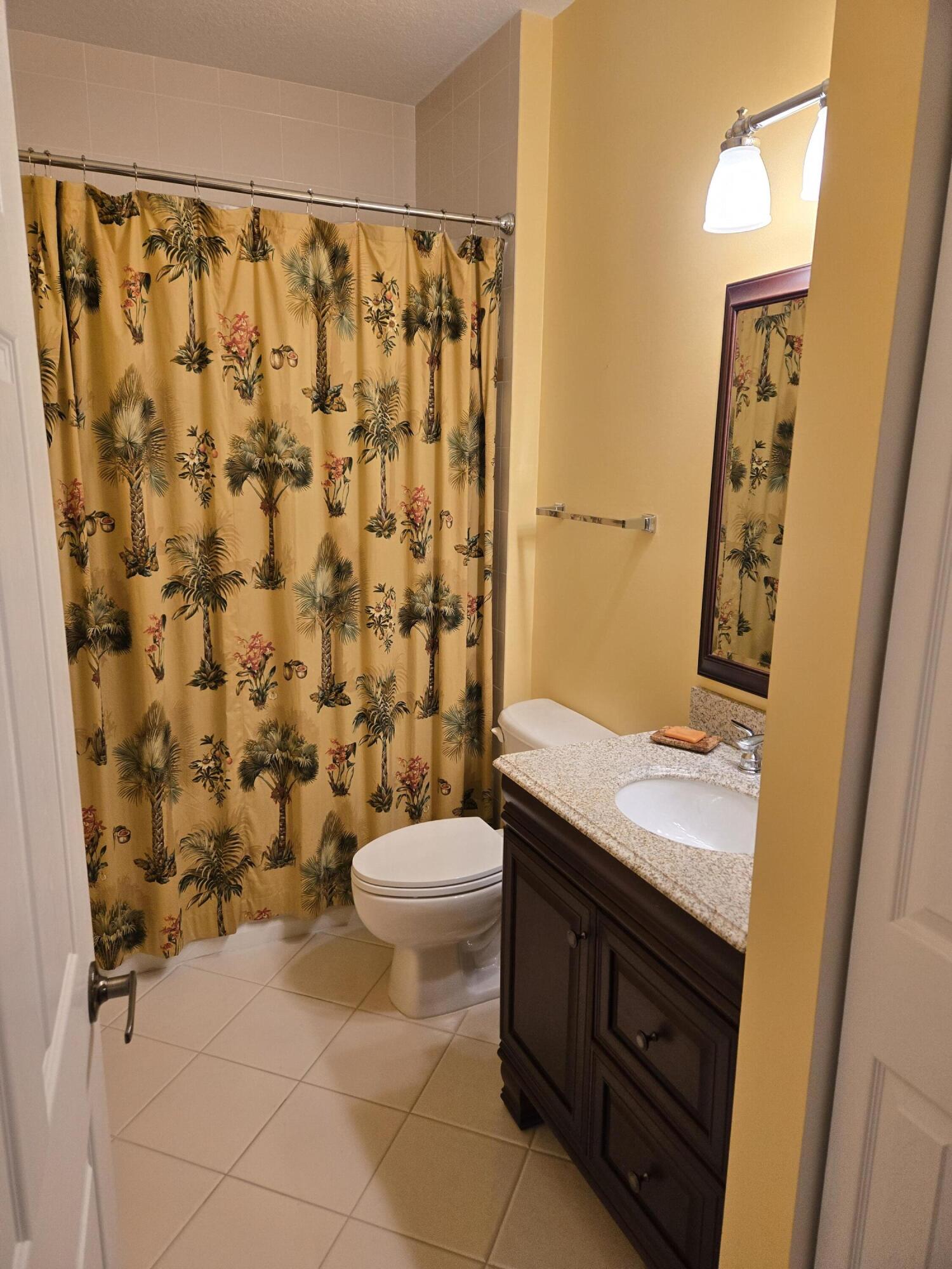 2297 Windjammer Way West Palm Beach, FL 33411 - Photo 16 of 56 a bathroom with a granite countertop toilet sink and a mirror
