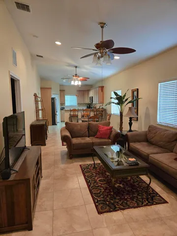 a living room with furniture and a chandelier