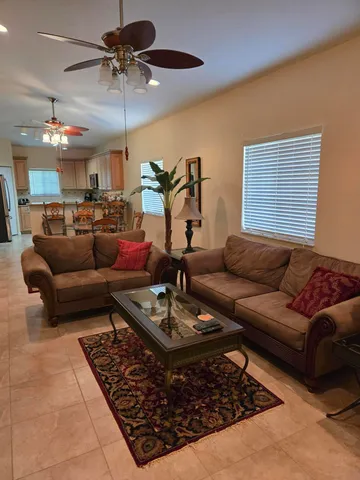 a kitchen with granite countertop wooden cabinets a sink a stove a refrigerator and island