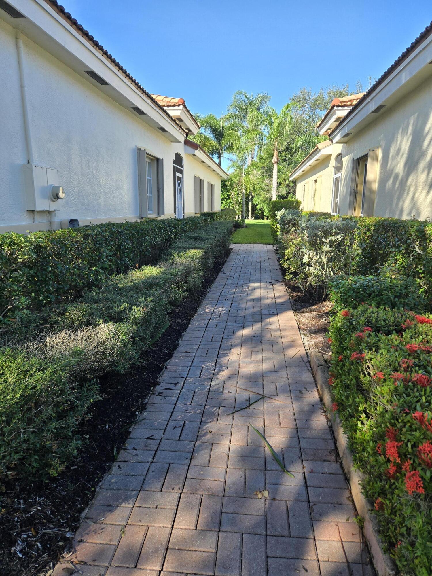 2297 Windjammer Way West Palm Beach, FL 33411 - Photo 2 of 56 a front view of a house with garden
