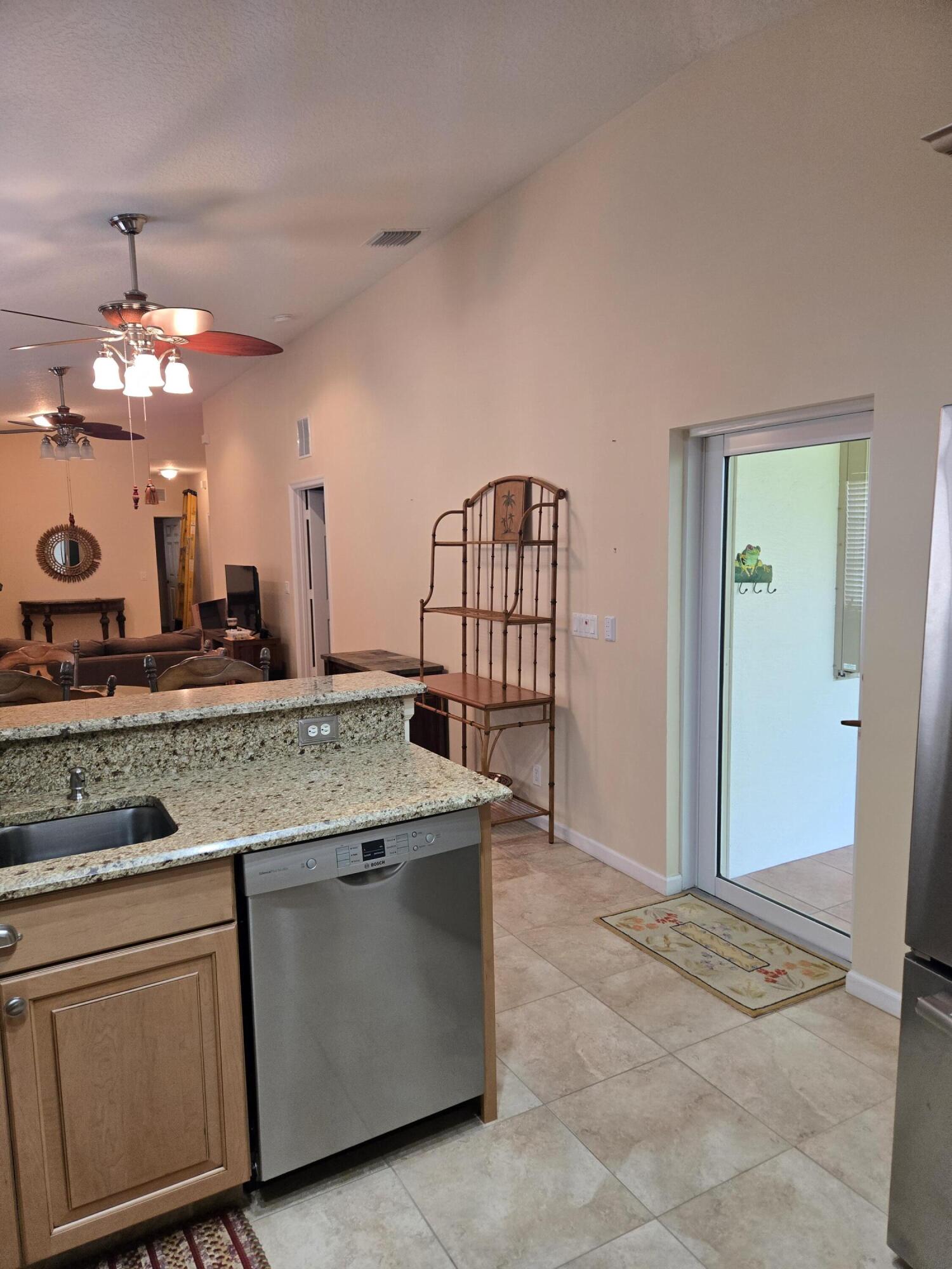 2297 Windjammer Way West Palm Beach, FL 33411 - Photo 23 of 56 a view of a kitchen with granite countertop a sink and dishwasher