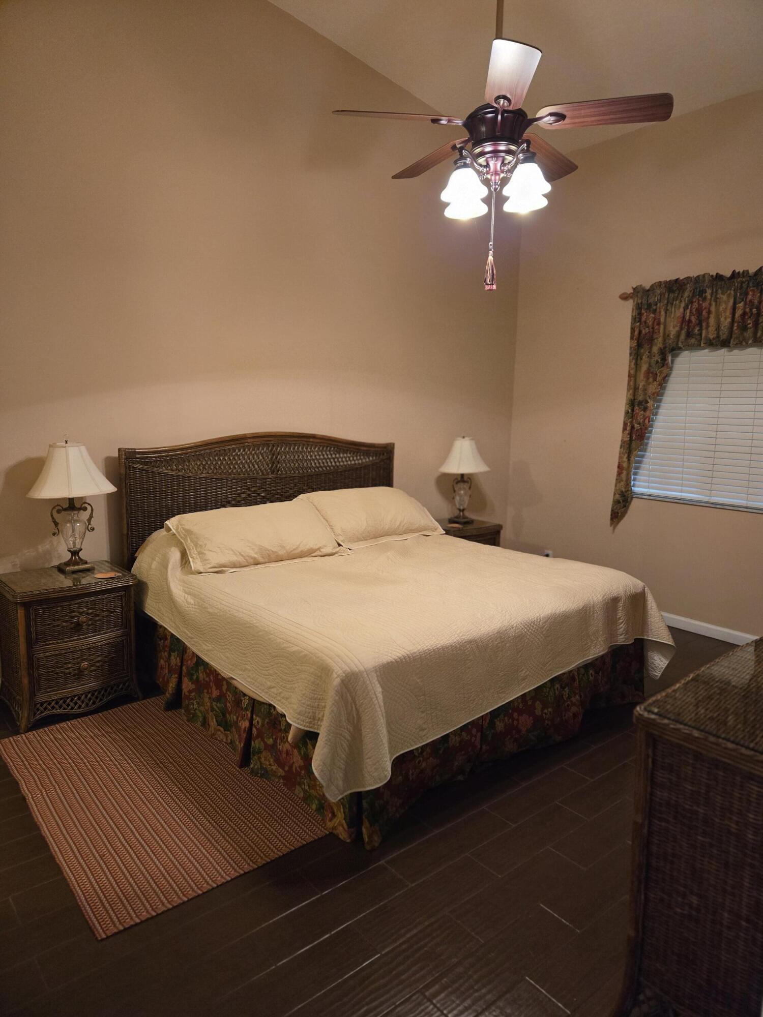 2297 Windjammer Way West Palm Beach, FL 33411 - Photo 25 of 56 a bedroom with a bed and a chandelier