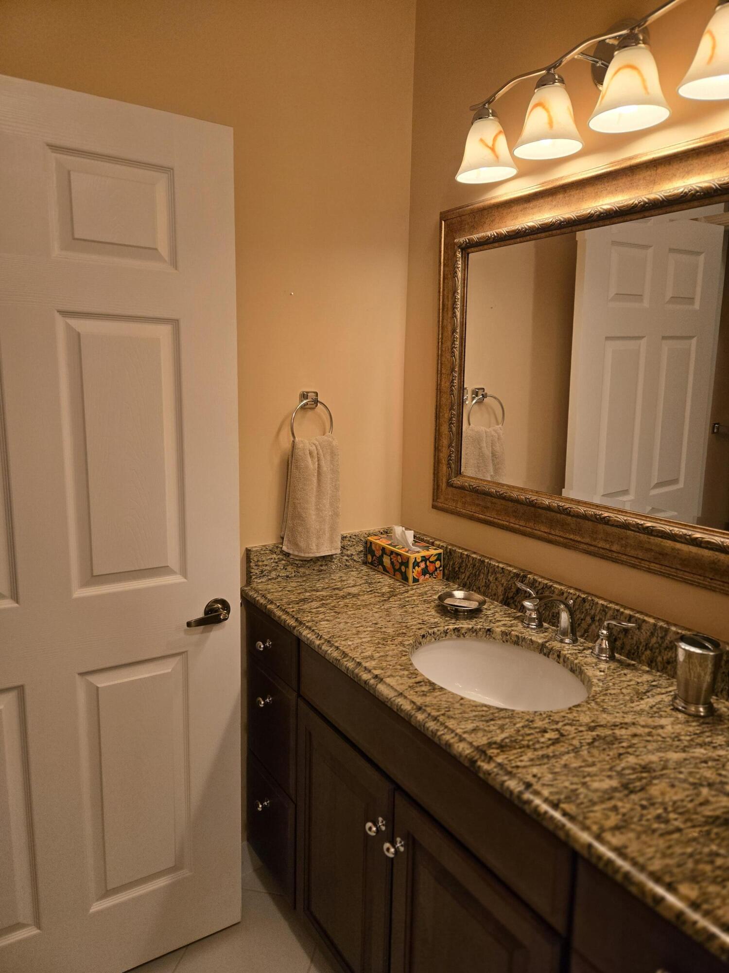 2297 Windjammer Way West Palm Beach, FL 33411 - Photo 30 of 56 a bathroom with a granite countertop sink and a mirror