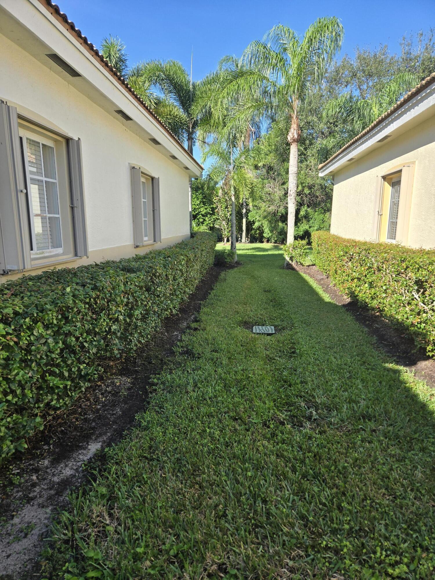 2297 Windjammer Way West Palm Beach, FL 33411 - Photo 3 of 56 a view of backyard with potted plants and large tree