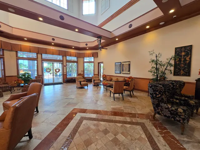 a living room with furniture and potted plants