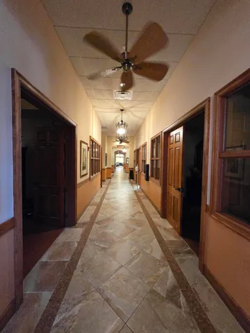 a room with pool table and windows