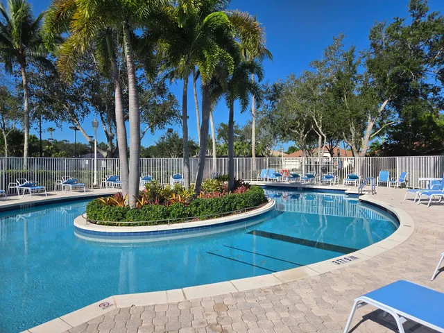 a view of a backyard and swimming pool
