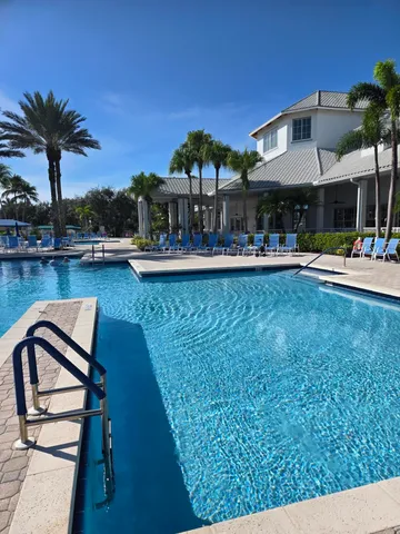 a front view of a house with swimming pool yard and outdoor seating
