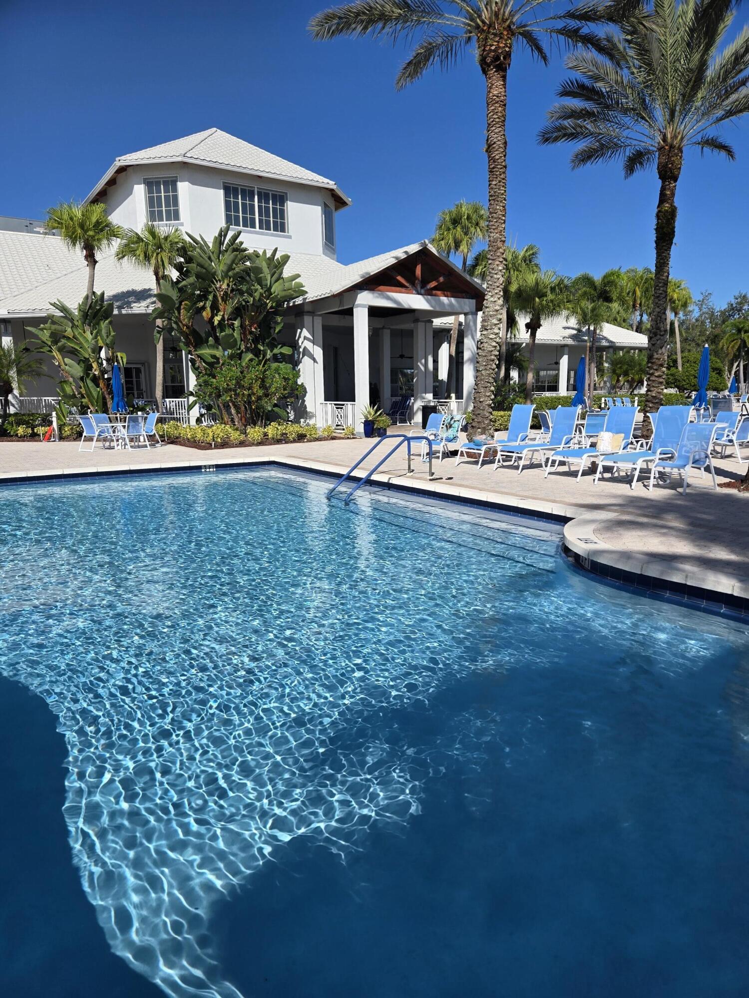 2297 Windjammer Way West Palm Beach, FL 33411 - Photo 47 of 56 a front view of a house with swimming pool yard and outdoor seating