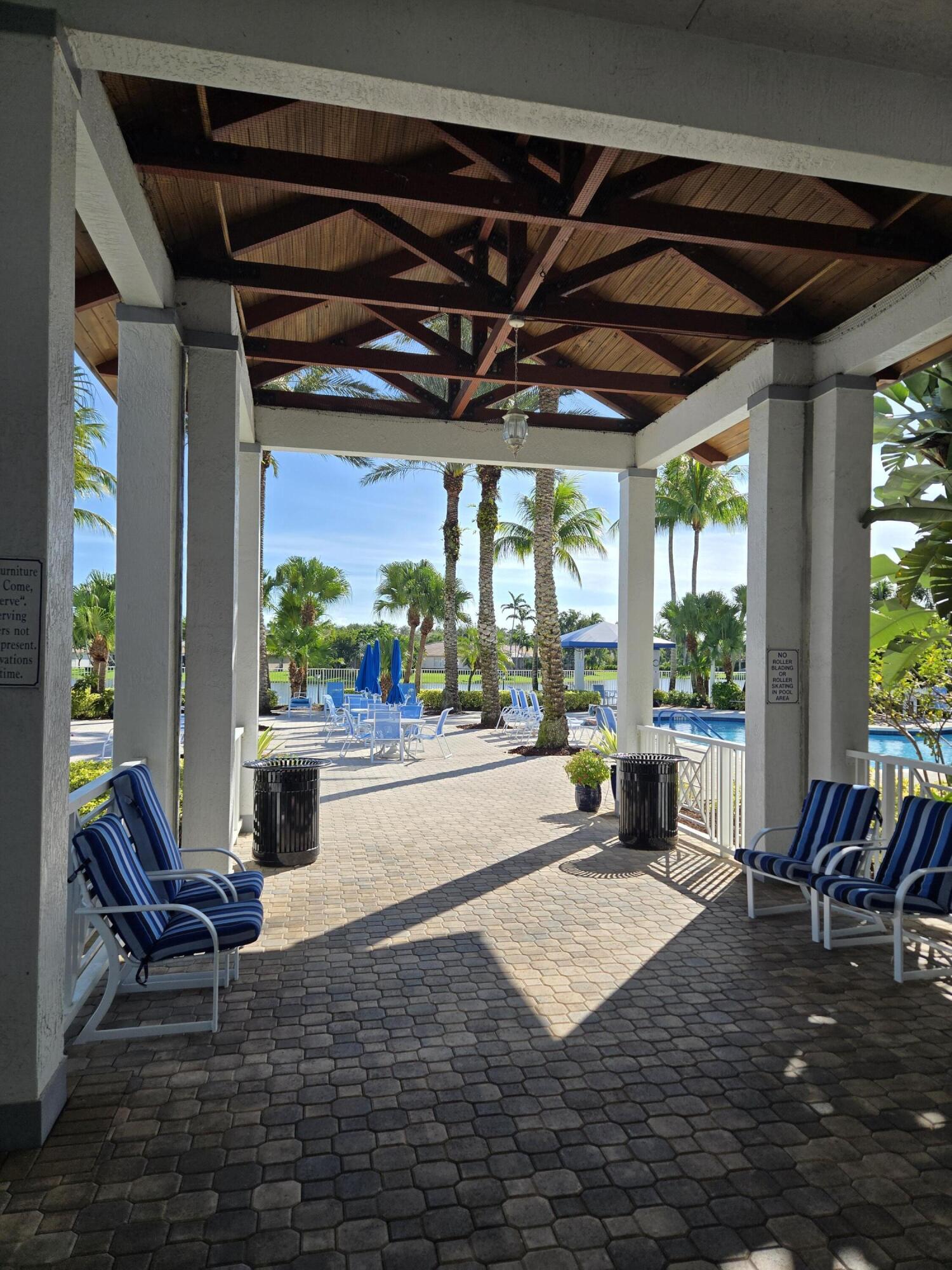 2297 Windjammer Way West Palm Beach, FL 33411 - Photo 48 of 56 a view of a patio with a table and chairs in the patio