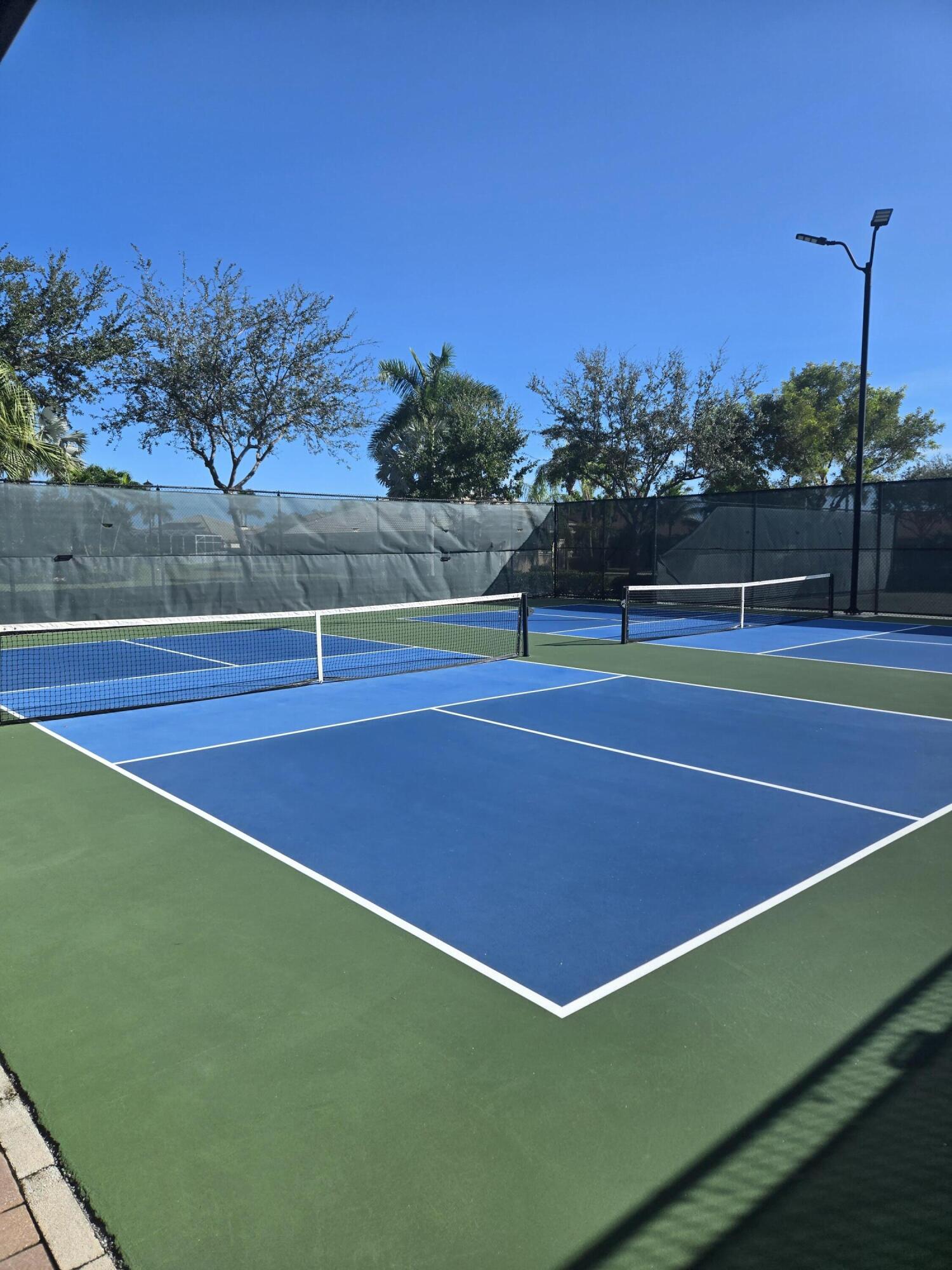 2297 Windjammer Way West Palm Beach, FL 33411 - Photo 52 of 56 a view of an outdoor space and tennis court