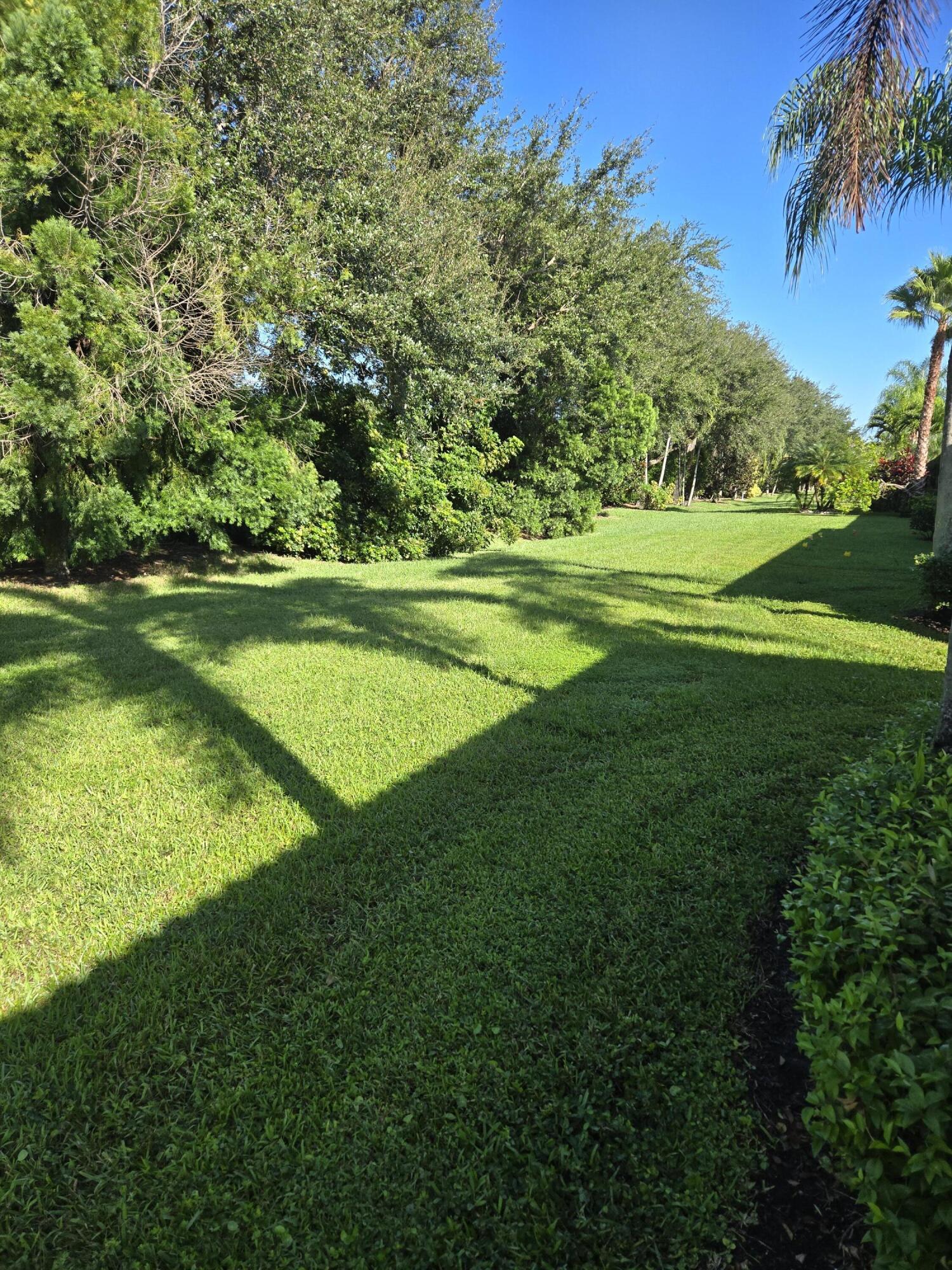 2297 Windjammer Way West Palm Beach, FL 33411 - Photo 9 of 56 a view of a golf course with a lake