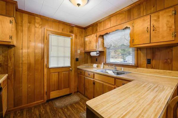 a room with stainless steel appliances a sink and cabinets
